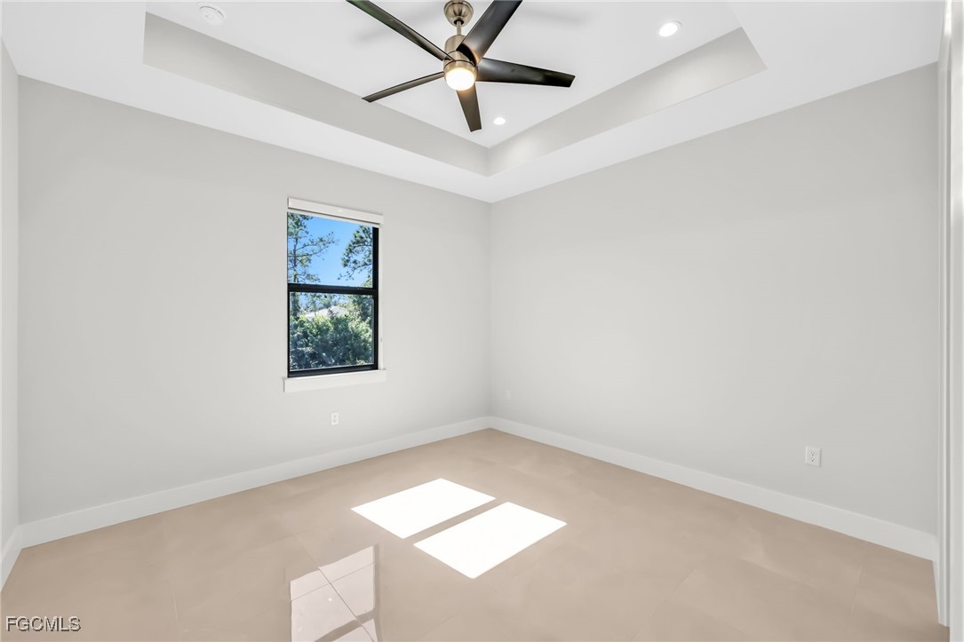8771-8773 Buckingham Road Lehigh Acres, FL 33971 - Photo 29 of 34 an empty room with a window and a ceiling fan