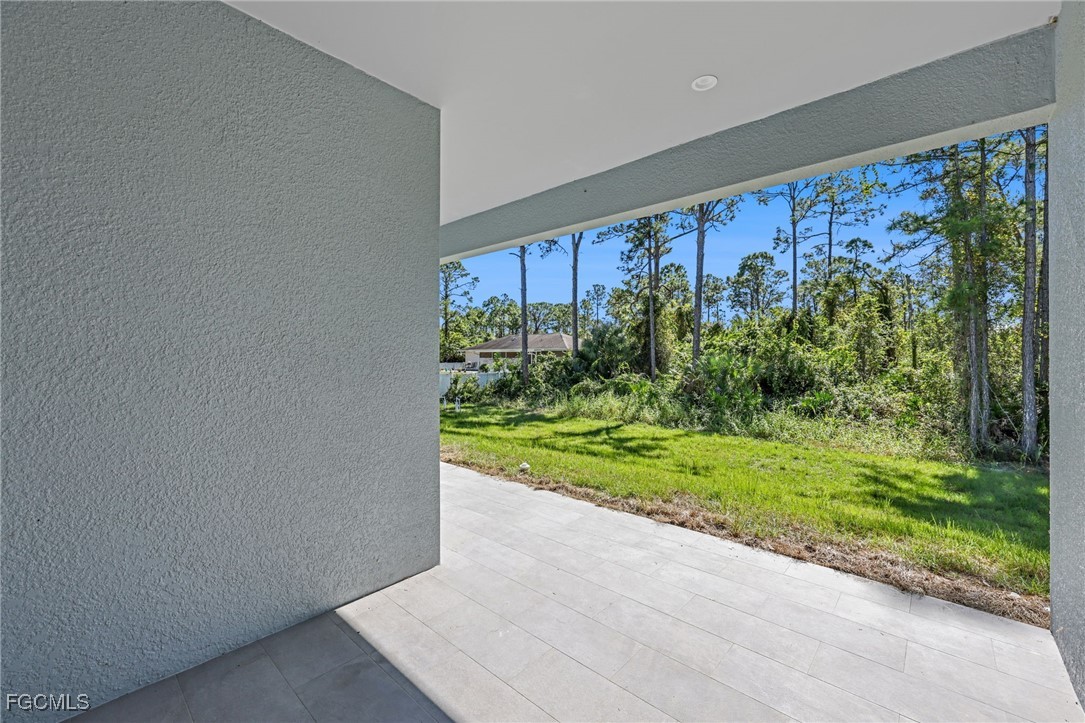 8771-8773 Buckingham Road Lehigh Acres, FL 33971 - Photo 32 of 34 a view of a back yard from a patio
