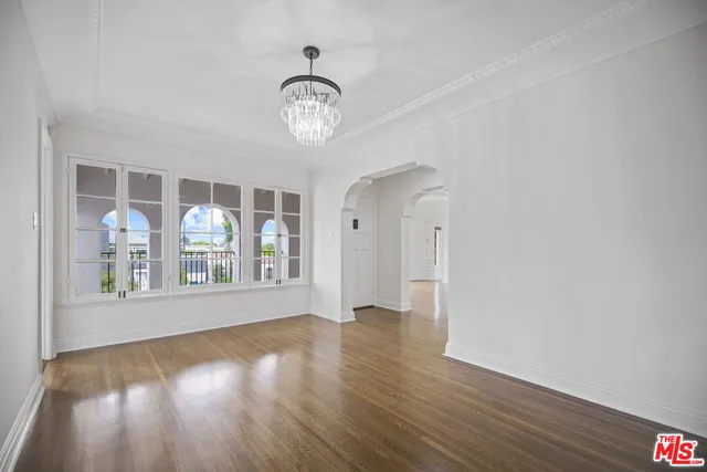a large kitchen with a lot of counter space and wooden floor