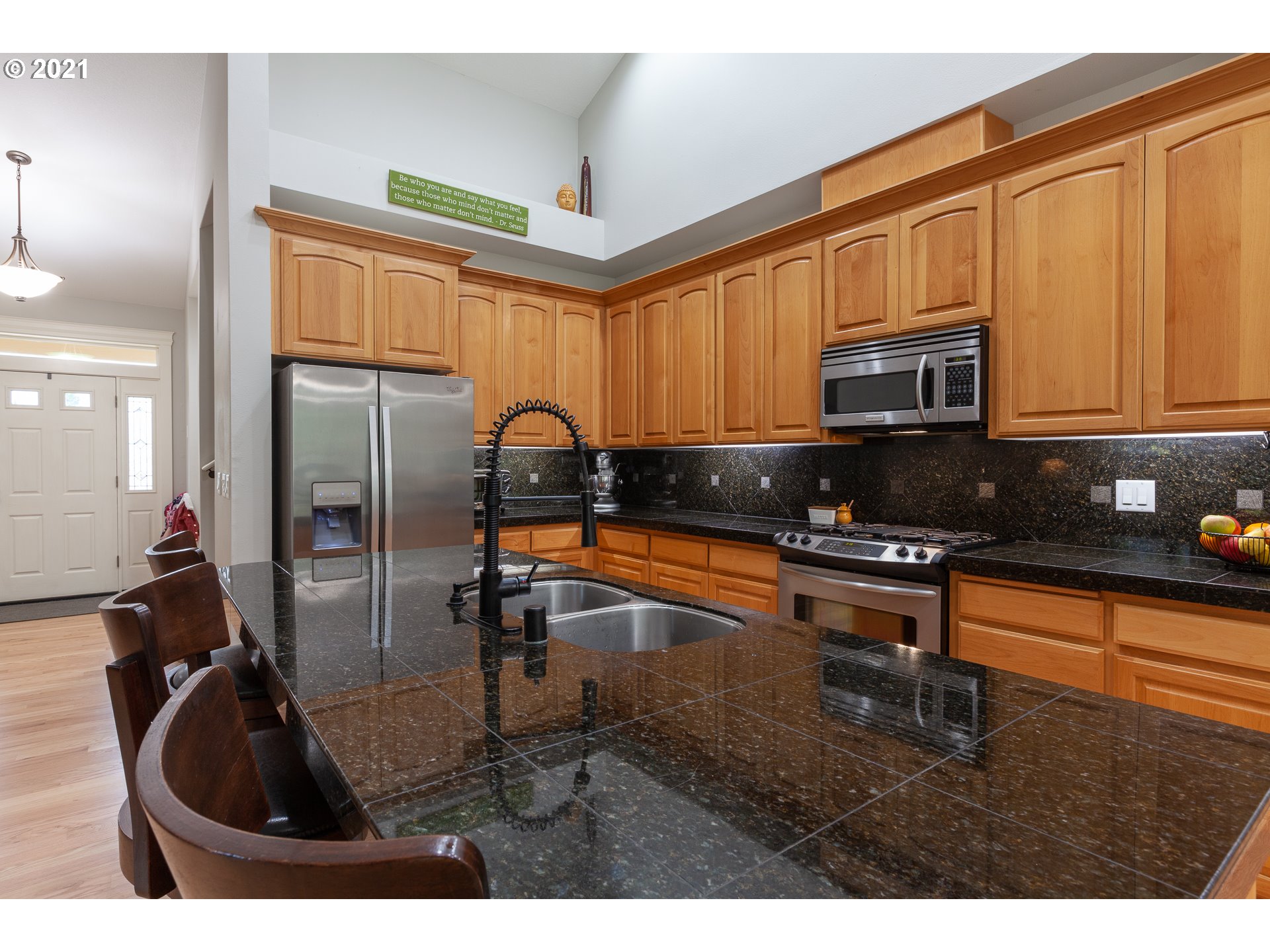 875 Northwest Angel Heights Road Stevenson, WA 98648 - Photo 11 of 32 a kitchen with stainless steel appliances granite countertop a refrigerator a stove and a sink with granite countertops