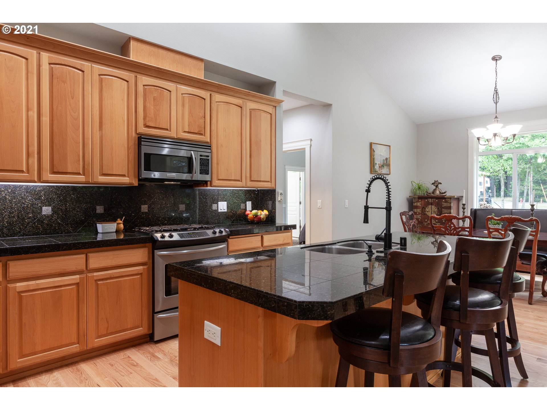 875 Northwest Angel Heights Road Stevenson, WA 98648 - Photo 12 of 32 a kitchen with kitchen island granite countertop a sink cabinets and stainless steel appliances