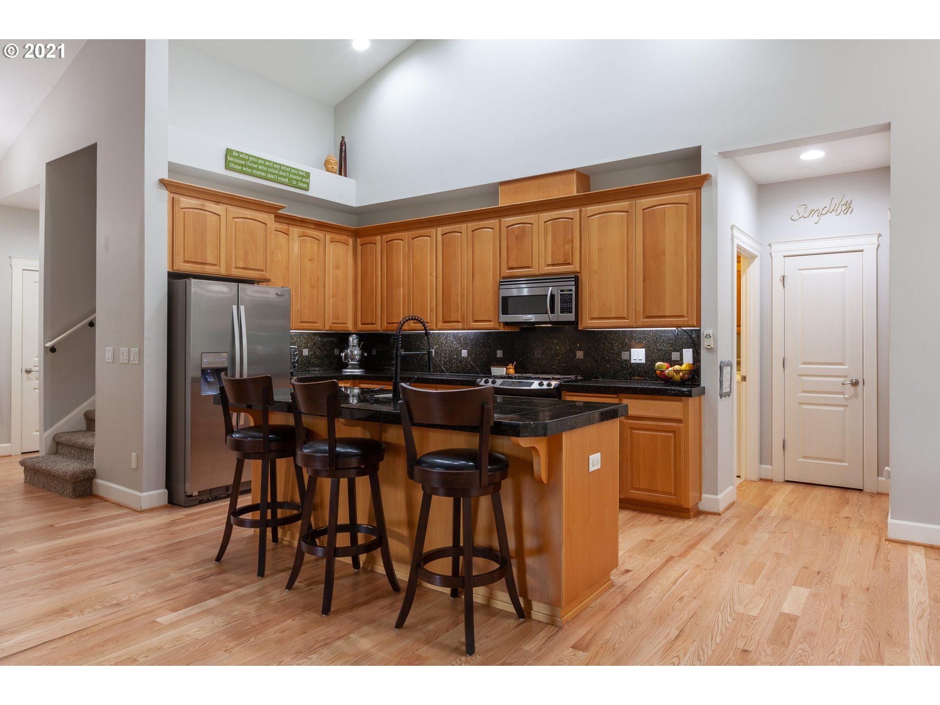 875 Northwest Angel Heights Road Stevenson, WA 98648 - Photo 14 of 32 a kitchen with stainless steel appliances granite countertop a stove a refrigerator a sink a dining table and chairs with wooden floor