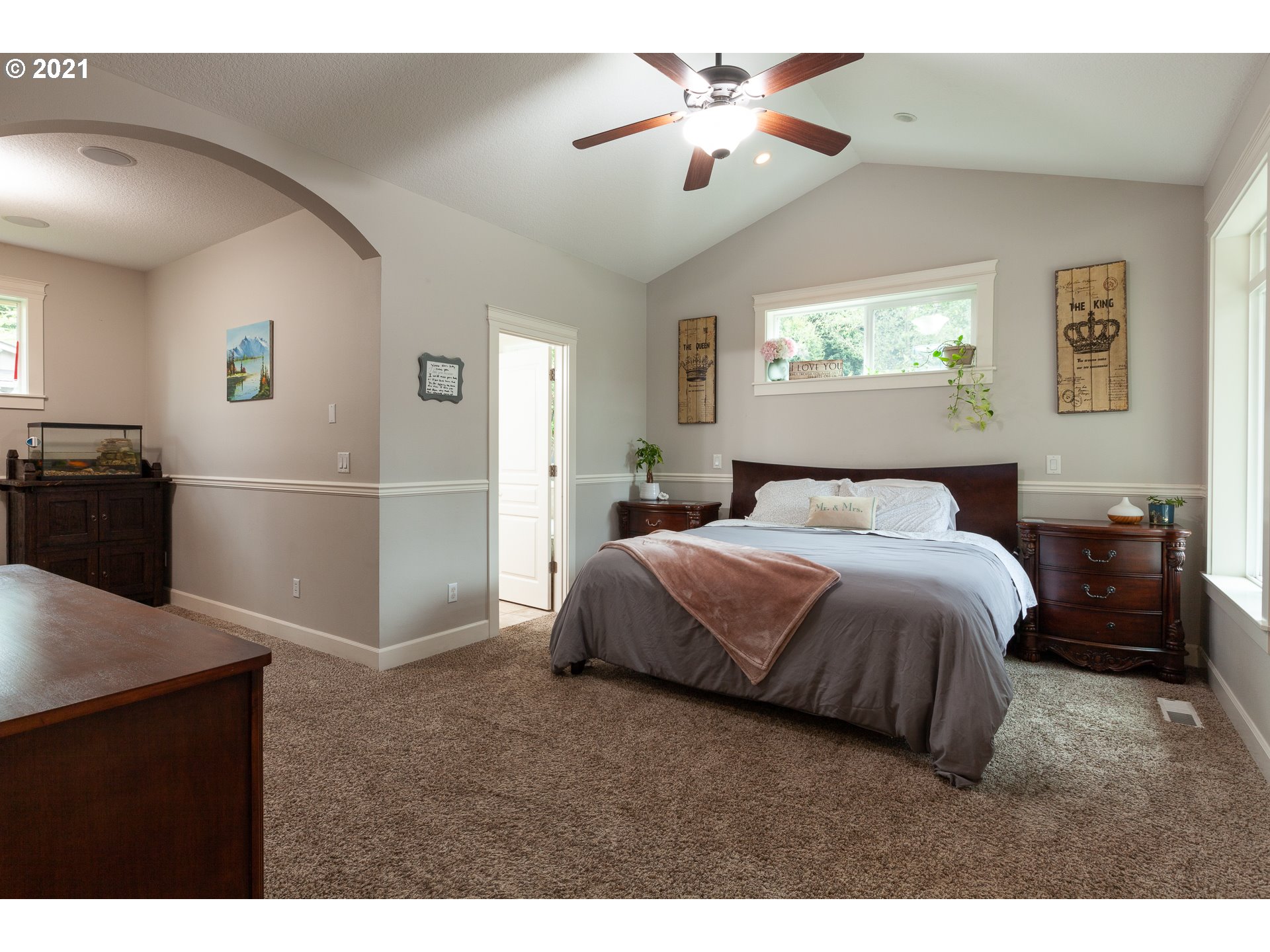 875 Northwest Angel Heights Road Stevenson, WA 98648 - Photo 19 of 32 a bedroom with a bed and a chandelier