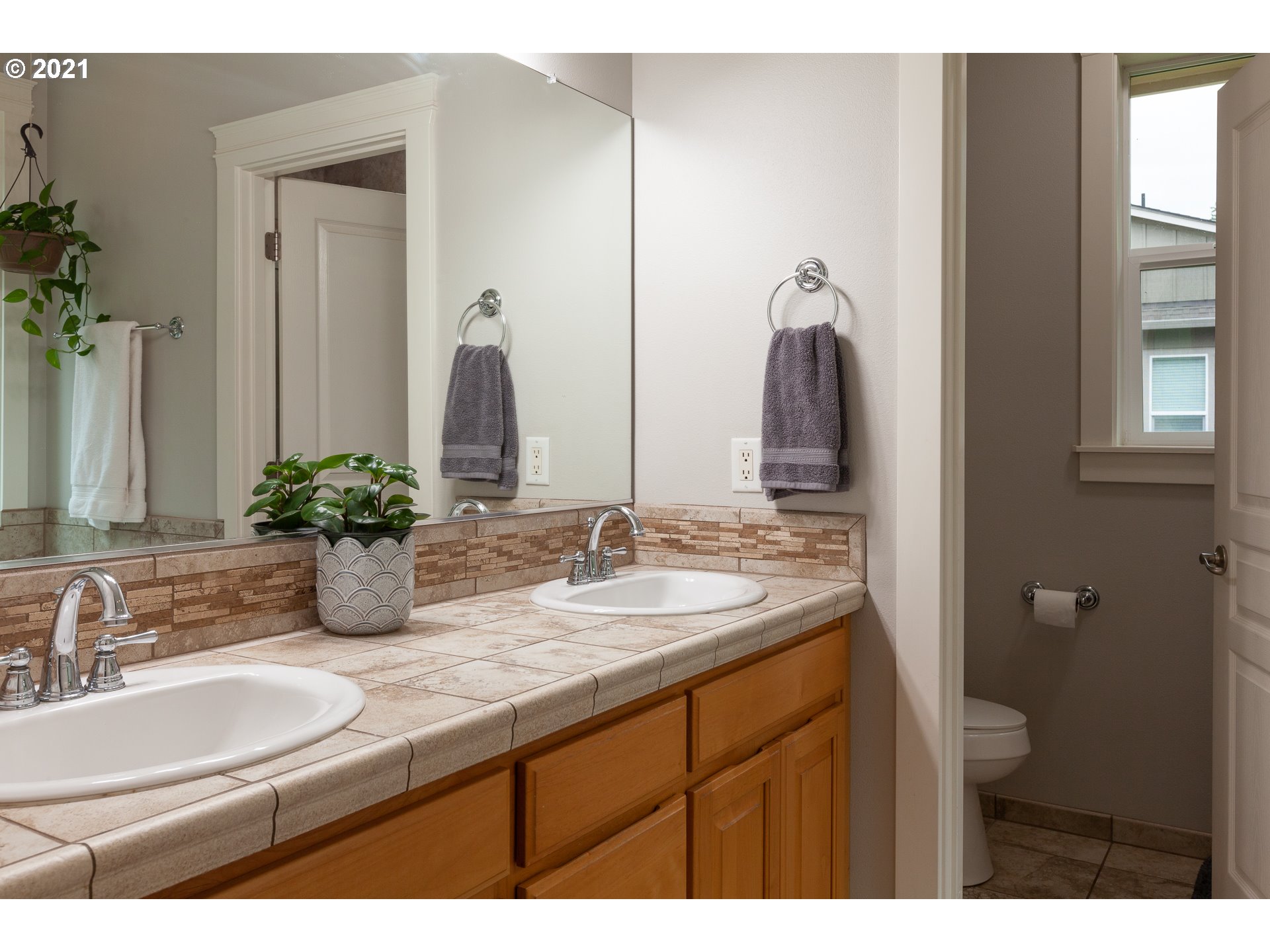 875 Northwest Angel Heights Road Stevenson, WA 98648 - Photo 22 of 32 a bathroom with a double vanity sink and a mirror