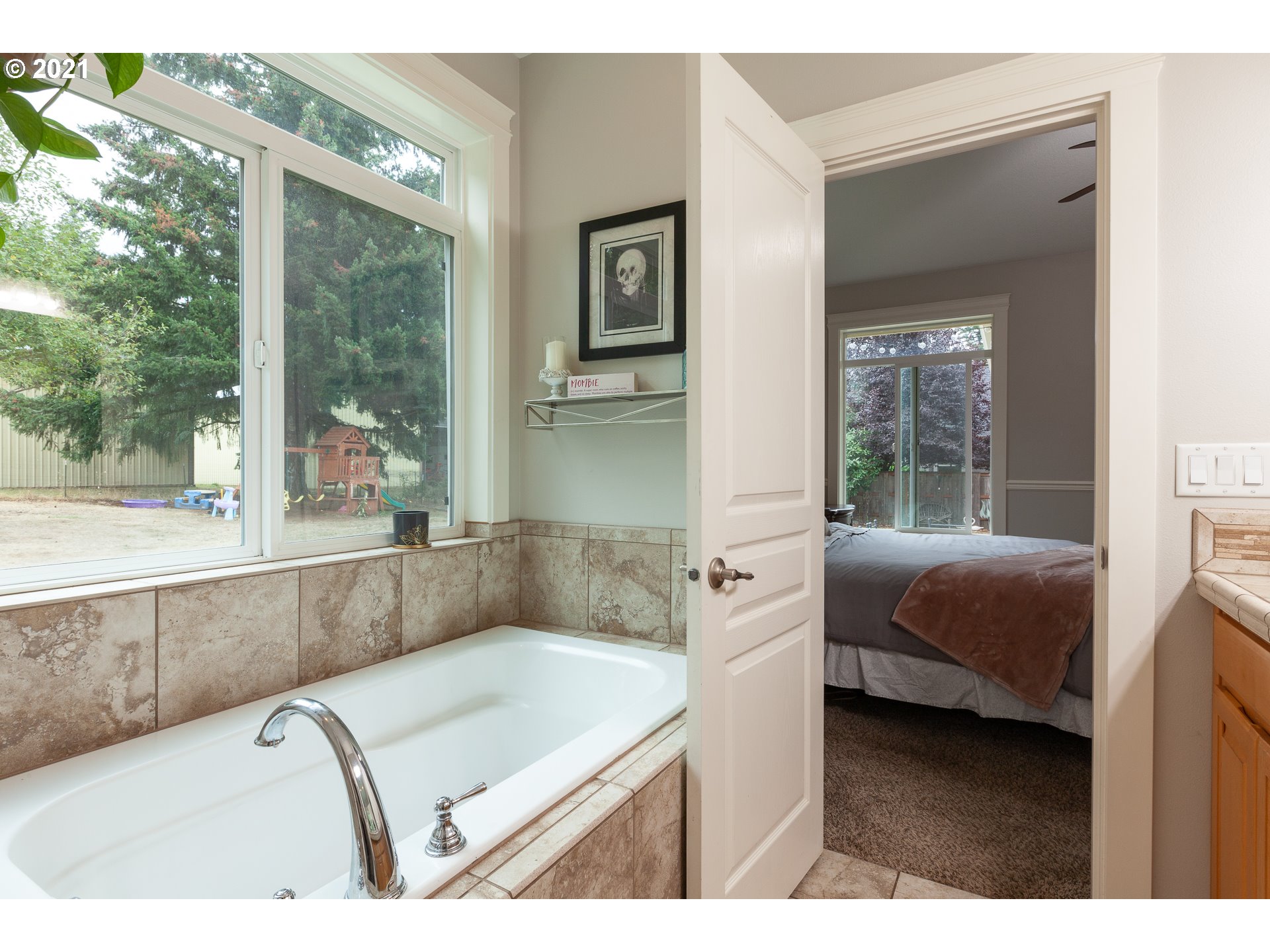 875 Northwest Angel Heights Road Stevenson, WA 98648 - Photo 23 of 32 a en suite bathroom with a granite countertop tub and a large window