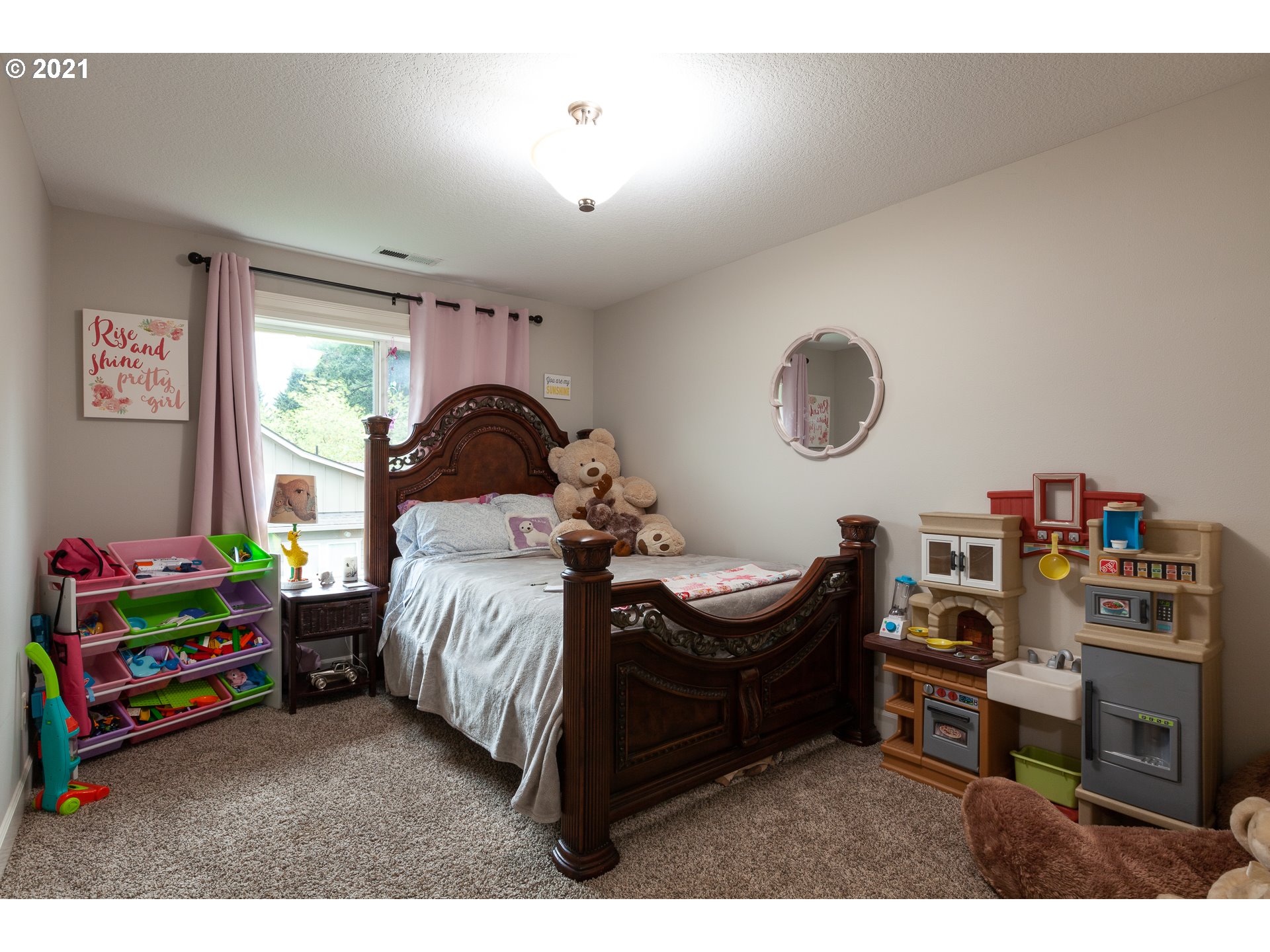 875 Northwest Angel Heights Road Stevenson, WA 98648 - Photo 31 of 32 a bedroom with a bed and a wooden floor