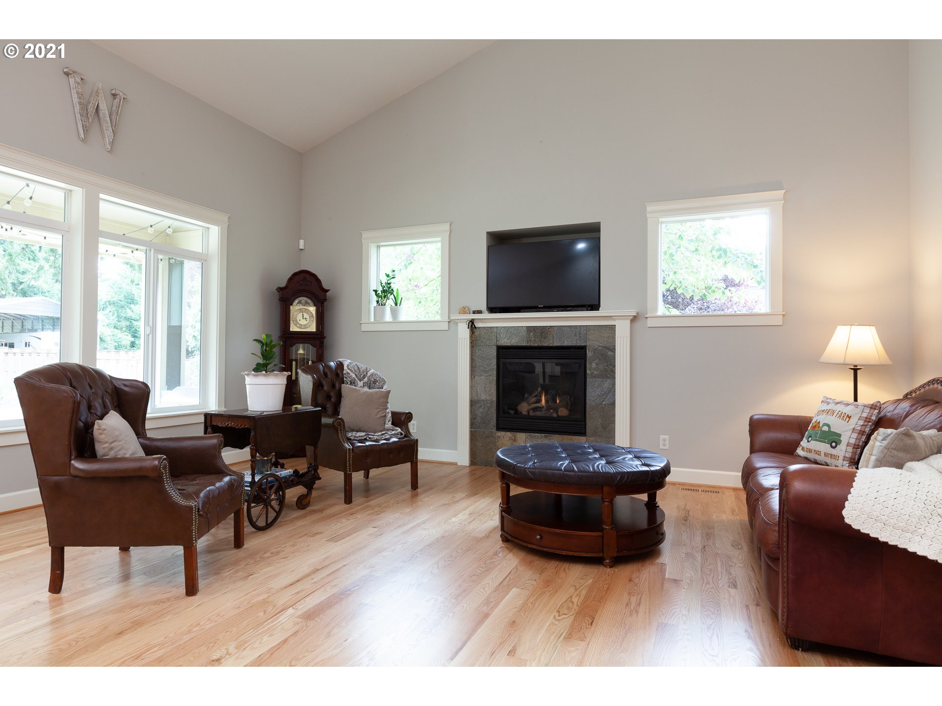 875 Northwest Angel Heights Road Stevenson, WA 98648 - Photo 9 of 32 a living room with furniture a flat screen tv and a fireplace