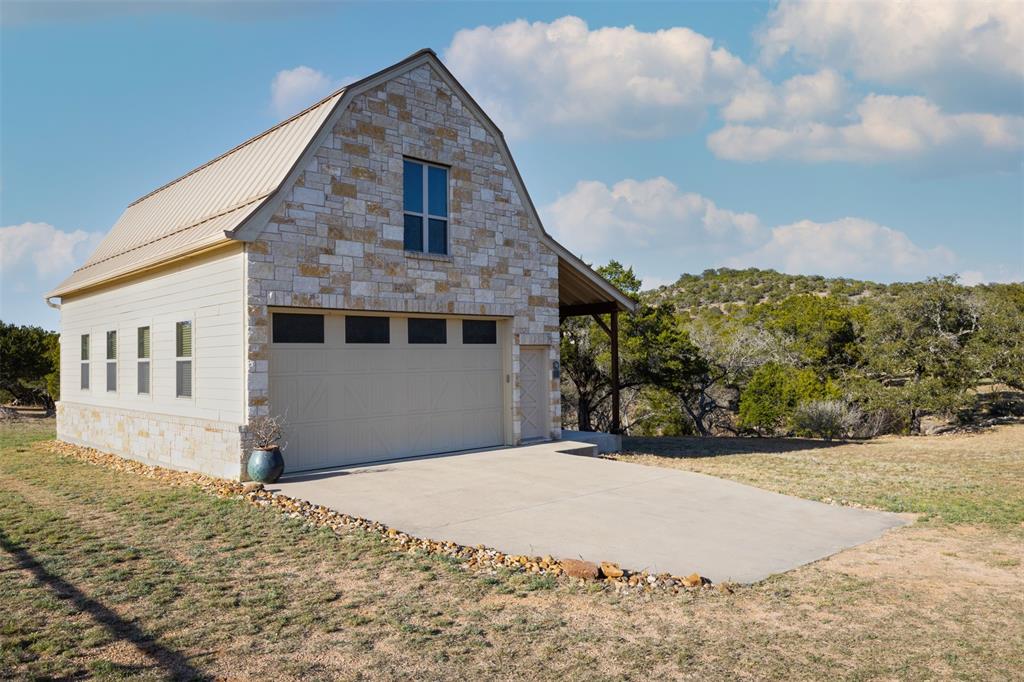 5300 Lookout Ridge Drive Marble Falls, TX 78654 - Photo 26 of 40 Barn garage door, front door, and windows