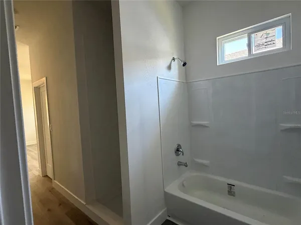 a bathroom with a bathtub and shower