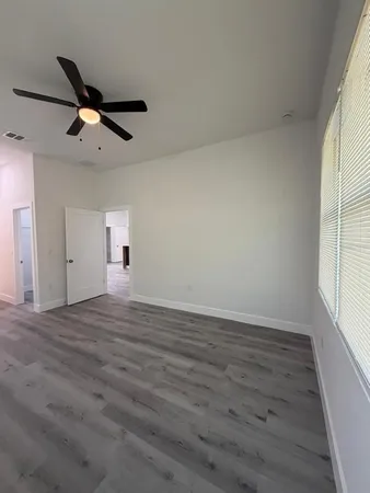 wooden floor in an empty room with a window