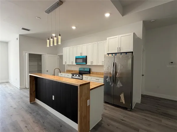 a kitchen with stainless steel appliances a refrigerator and a stove