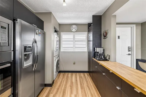 a living room with furniture a flat screen tv and a floor to ceiling window