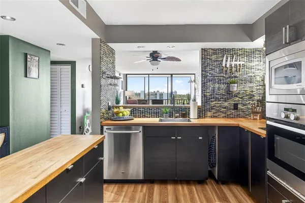 a living room with furniture large window and flat screen tv