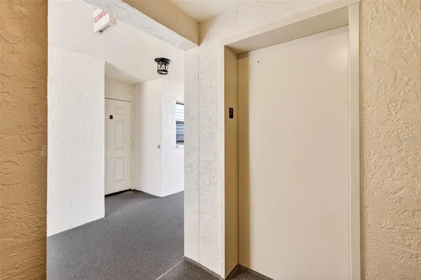 a view of a kitchen with stainless steel appliances granite countertop a refrigerator and a wooden floor
