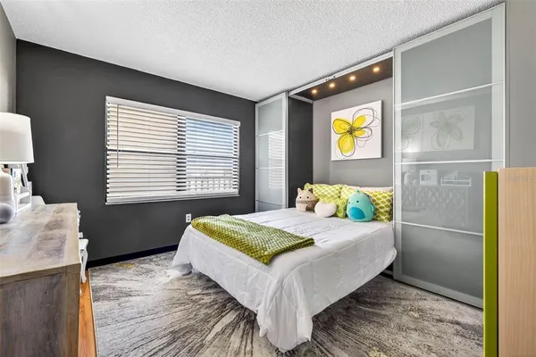 a bed room with a bed window and a television