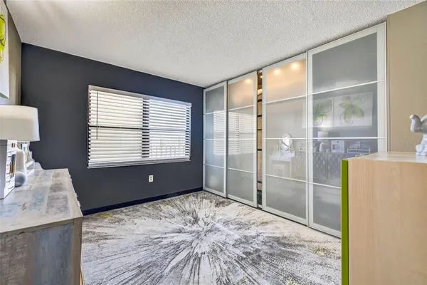 a bedroom with a large bed and a dresser