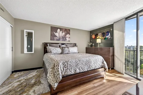 a view of a bedroom with a bed and a window