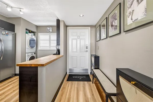 a kitchen with stainless steel appliances granite countertop a refrigerator a stove and a sink