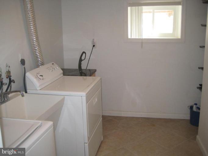 9607 Flower Avenue Silver Spring, MD 20901 - Photo 12 of 24 Separate room with utility sink and shelving