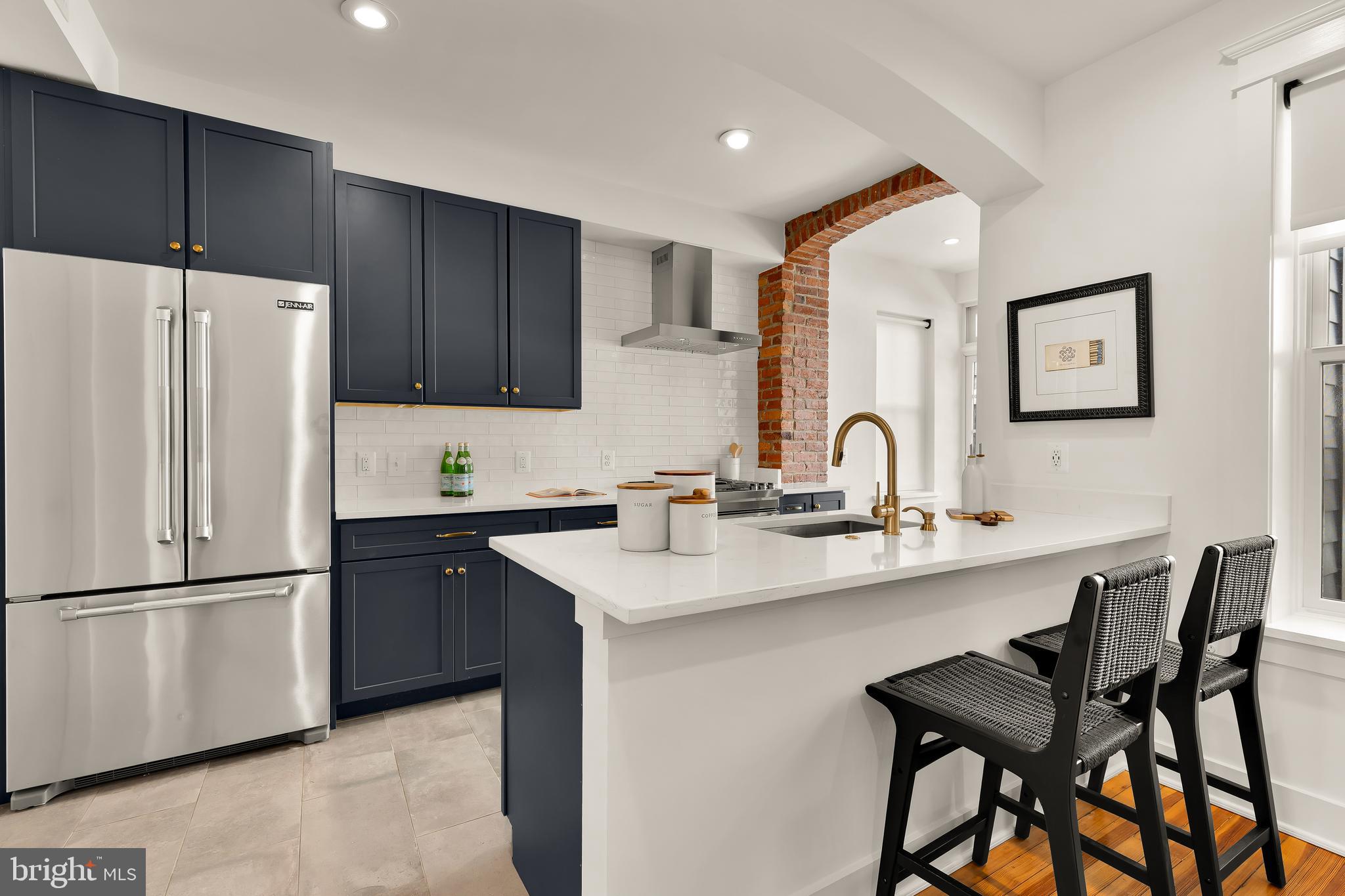 409 Columbia Road Northwest Washington, DC 20001 - Photo 12 of 41 a kitchen with stainless steel appliances a sink and a refrigerator