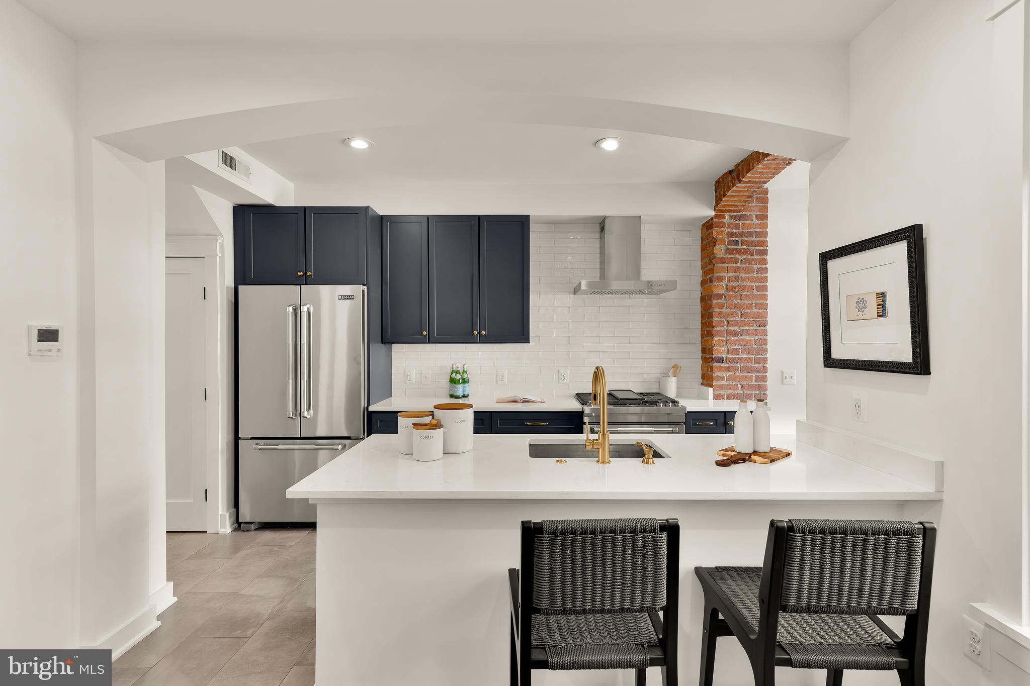 409 Columbia Road Northwest Washington, DC 20001 - Photo 13 of 41 a kitchen with stainless steel appliances a sink a stove a refrigerator and cabinets