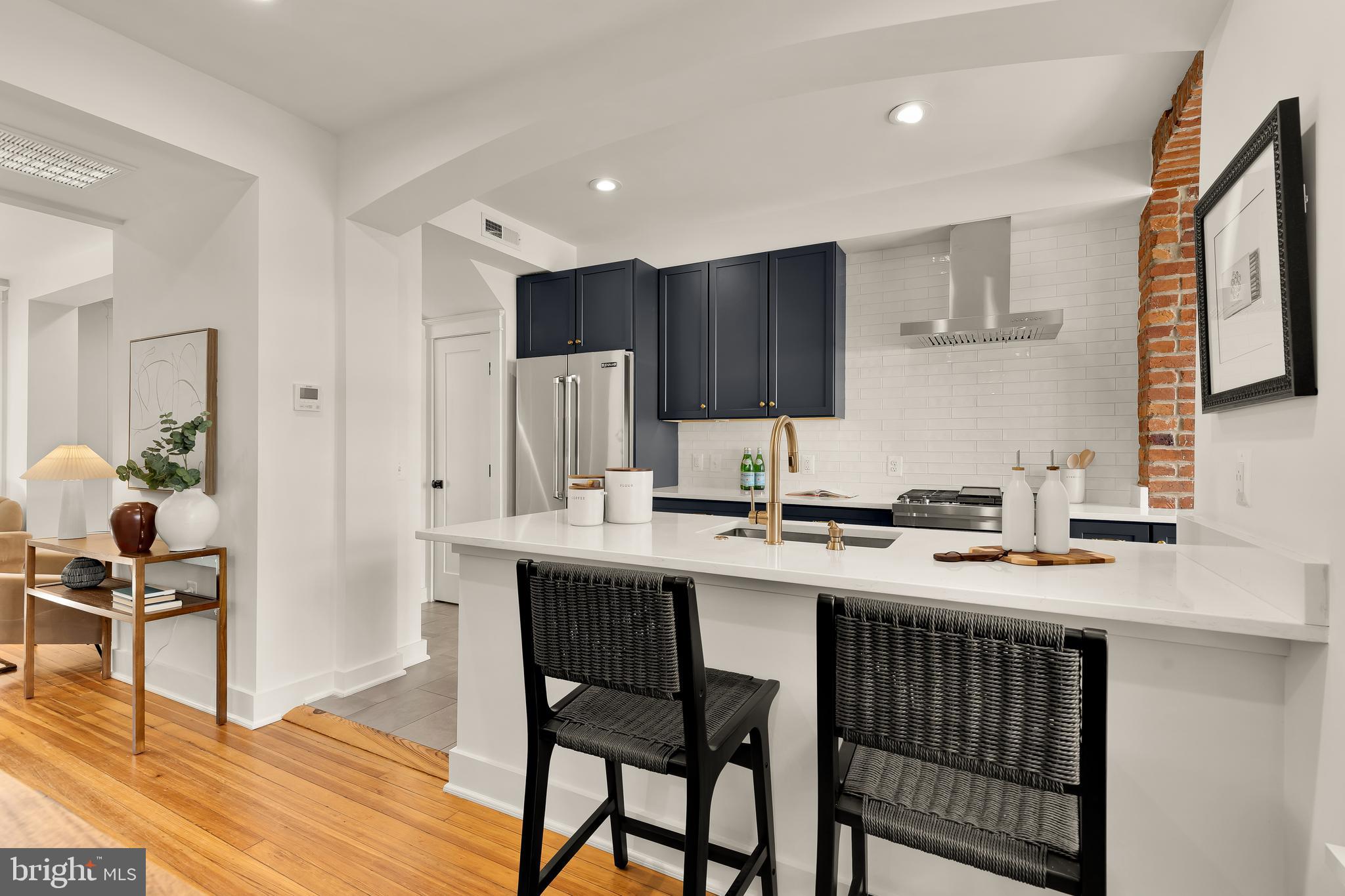409 Columbia Road Northwest Washington, DC 20001 - Photo 14 of 41 a kitchen that has a table chairs and a refrigerator