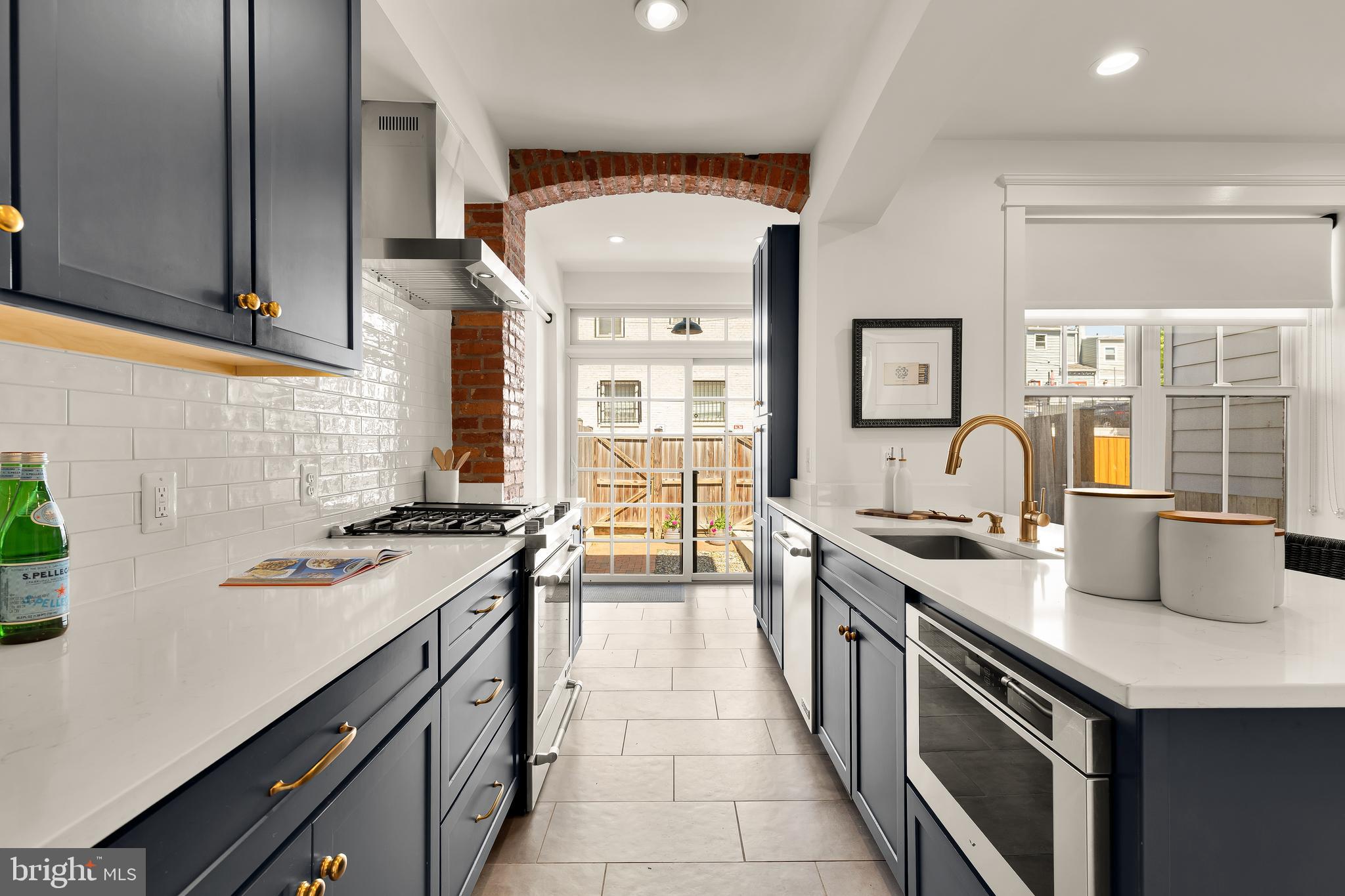 409 Columbia Road Northwest Washington, DC 20001 - Photo 16 of 41 a kitchen with stainless steel appliances a sink stove and cabinets