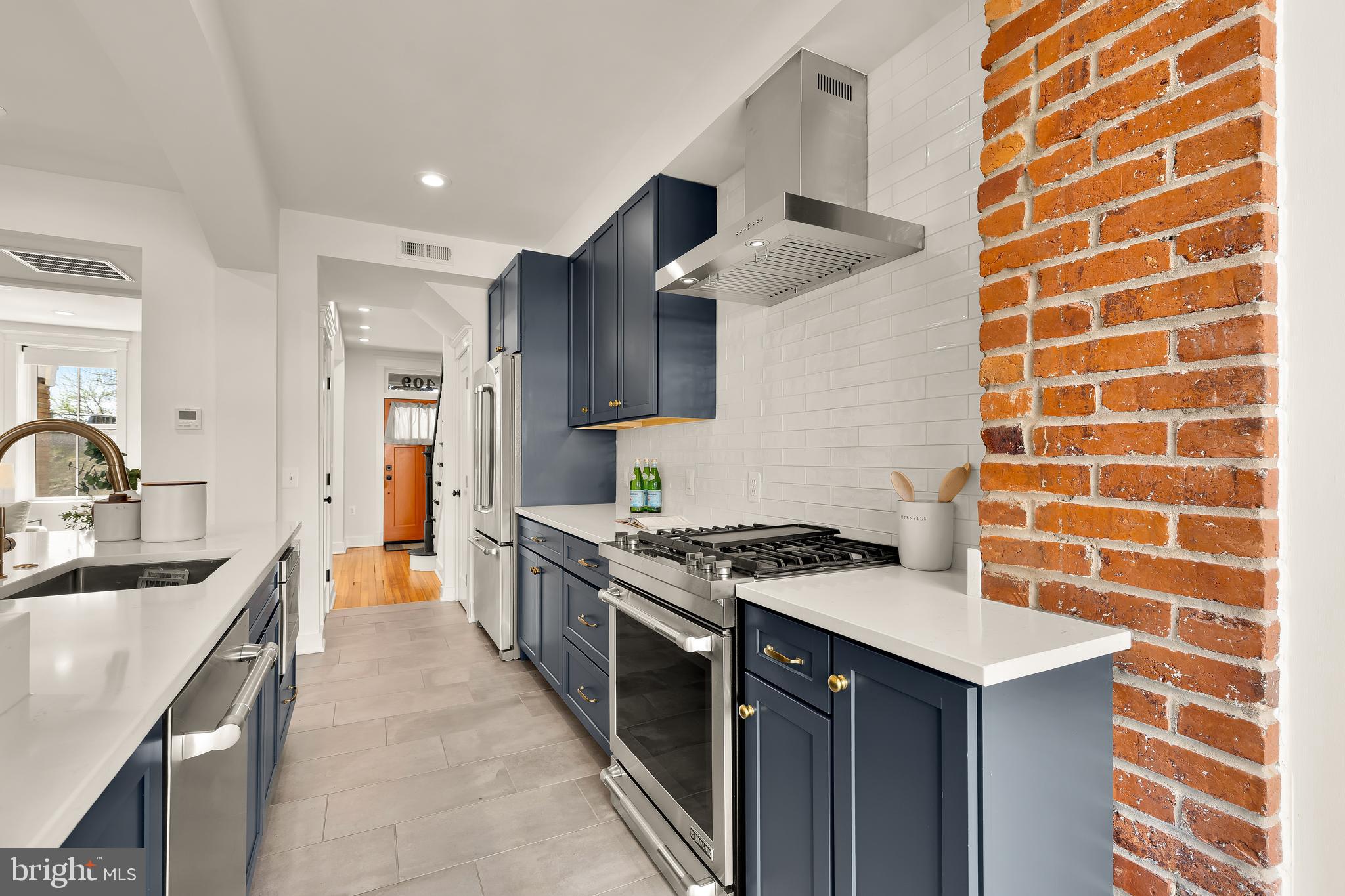 409 Columbia Road Northwest Washington, DC 20001 - Photo 17 of 41 a kitchen with stainless steel appliances granite countertop a stove and a sink