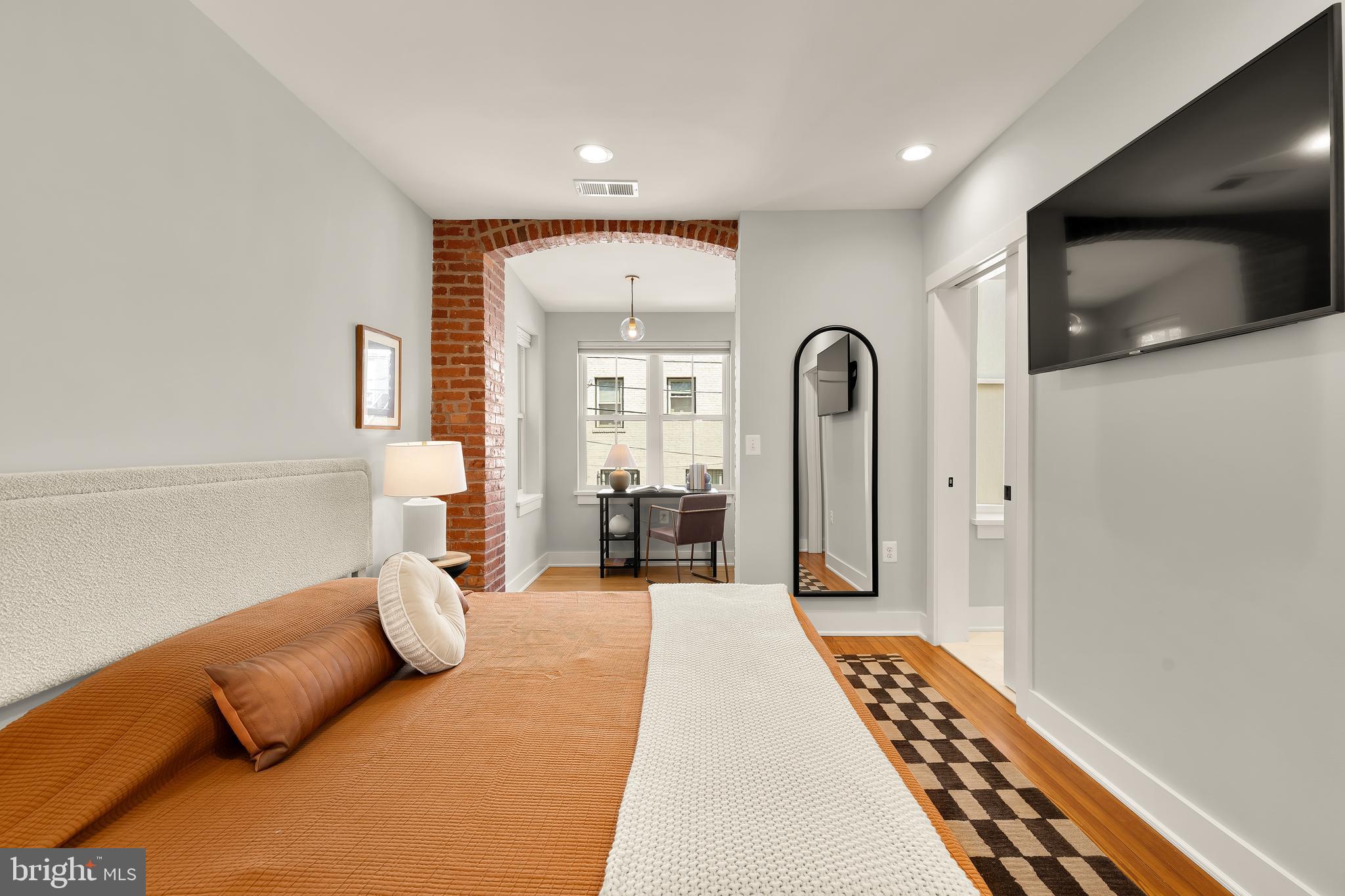 409 Columbia Road Northwest Washington, DC 20001 - Photo 23 of 41 a bedroom with furniture and a flat screen tv