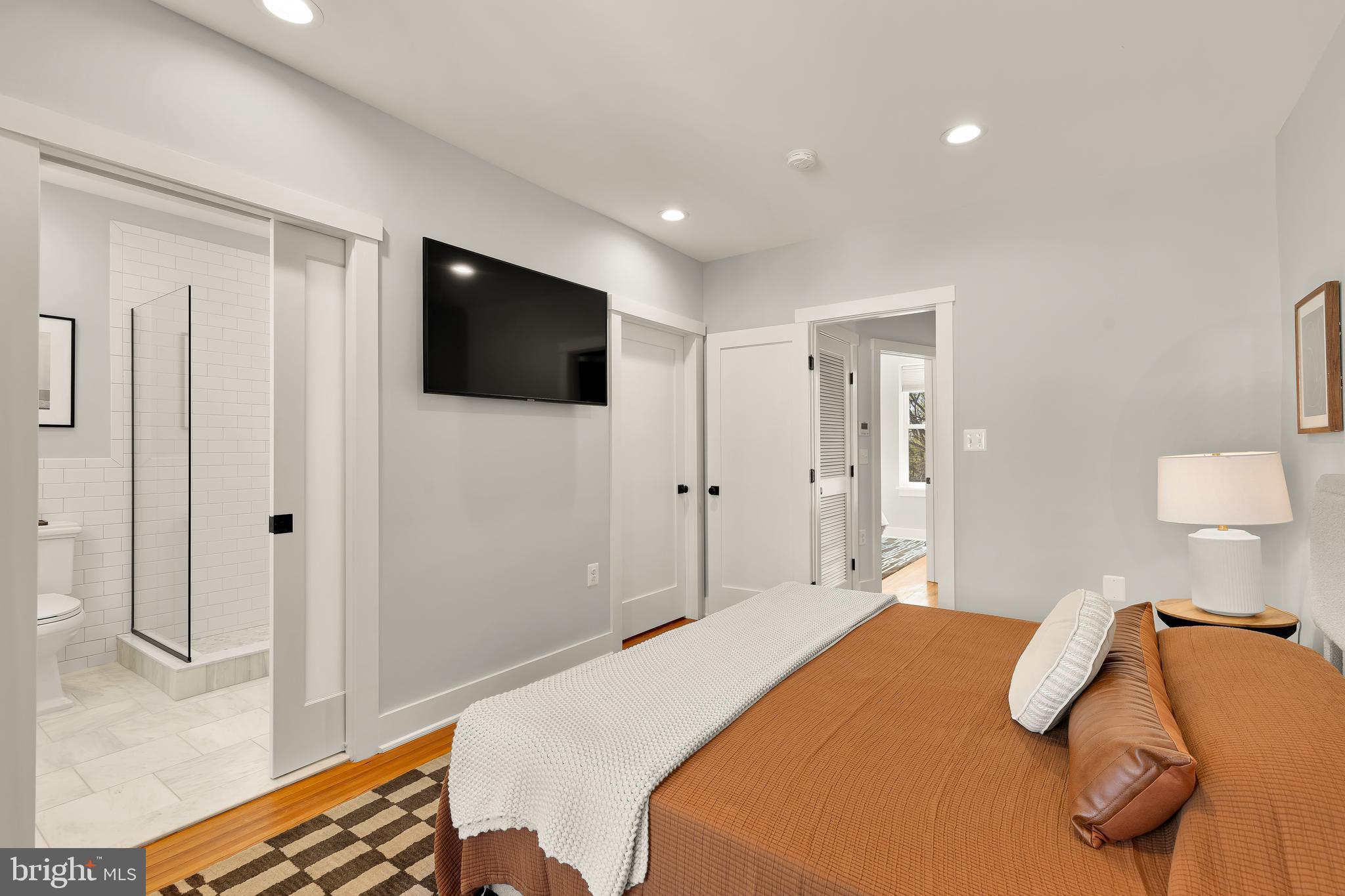 409 Columbia Road Northwest Washington, DC 20001 - Photo 26 of 41 a bedroom with a bed and a flat screen tv