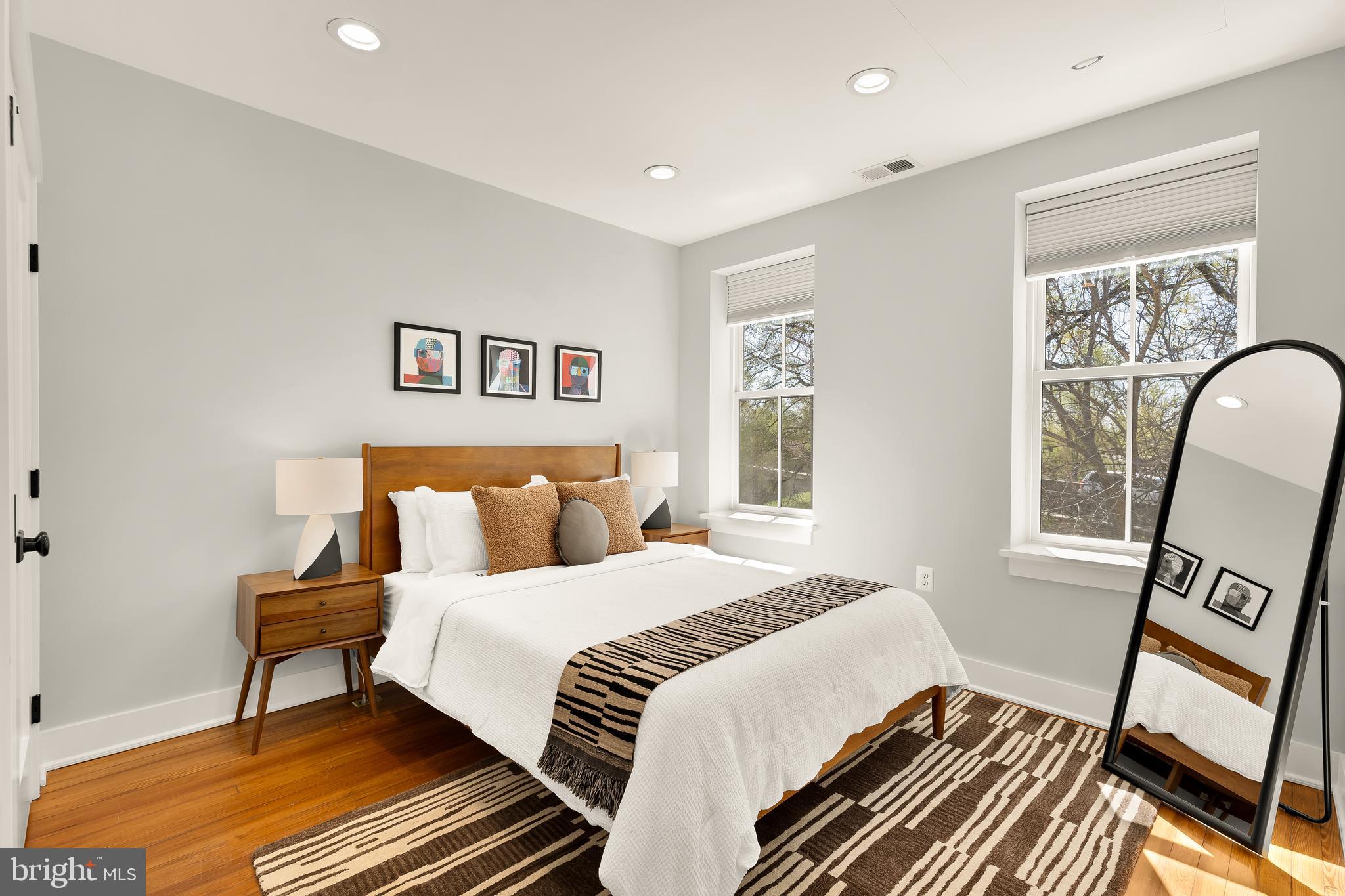 409 Columbia Road Northwest Washington, DC 20001 - Photo 30 of 41 a bedroom with a bed and wooden floor