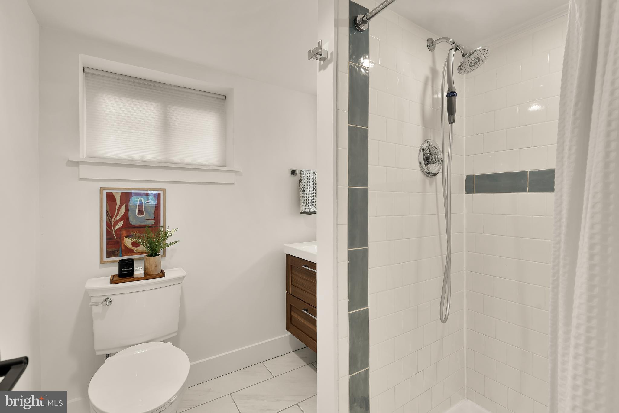 409 Columbia Road Northwest Washington, DC 20001 - Photo 41 of 41 a bathroom with a toilet sink vanity and shower