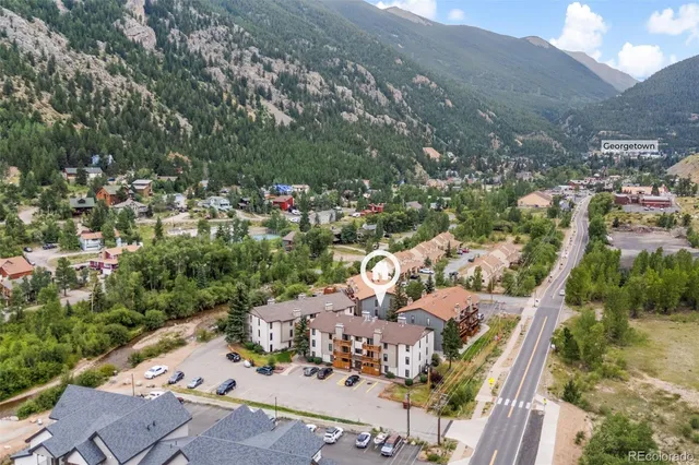 an aerial view of a house with a yard basket ball court and outdoor seating