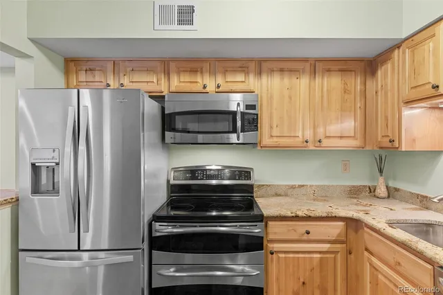 a kitchen with a refrigerator stove and microwave