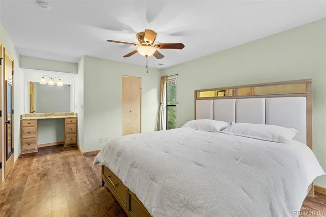 a bedroom with a large bed and a chandelier