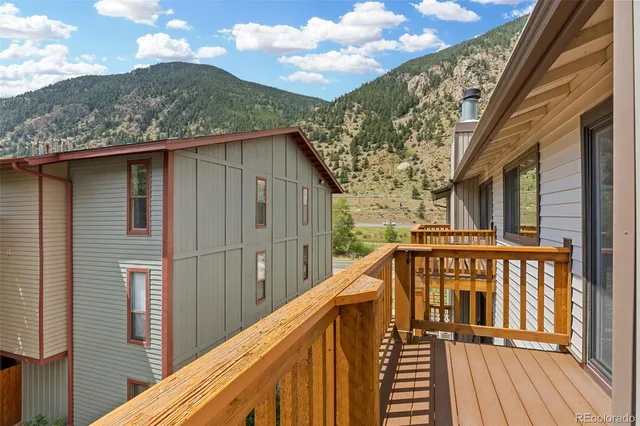a view of balcony with wooden floor and fence