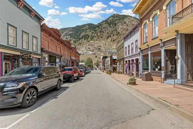 a view of a cars park in front of a building