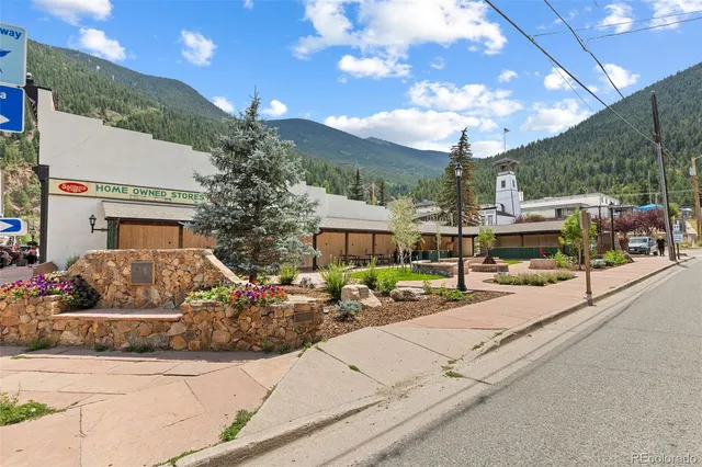 a front view of a building with sitting area