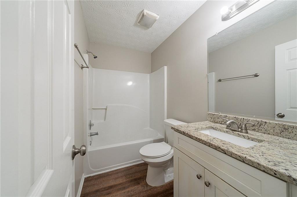 2183 Ramblewood Circle Decatur, GA 30035 - Photo 25 of 37 a bathroom with a granite countertop sink a toilet and shower