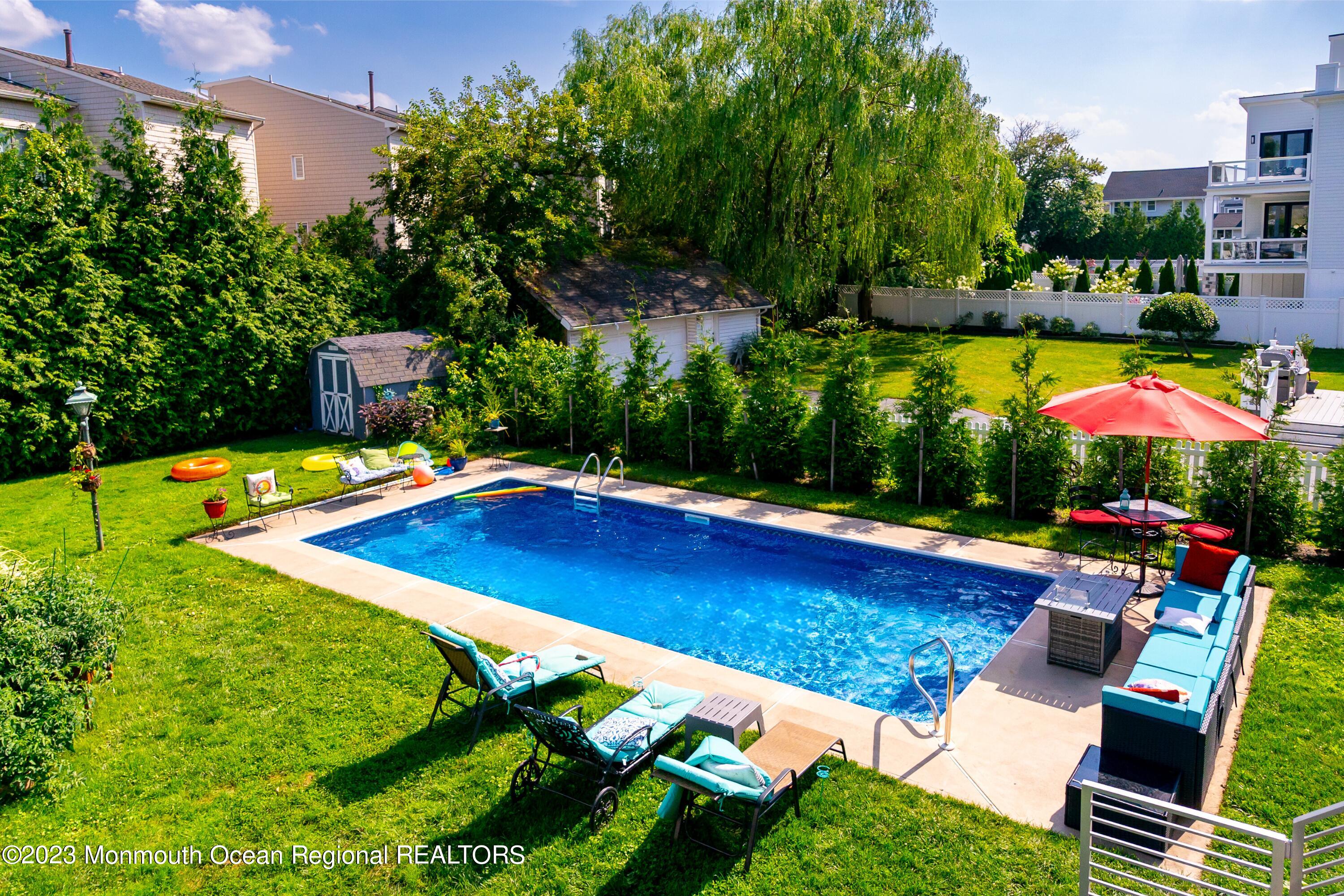 an outdoor space with swimming pool and furniture