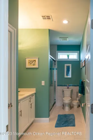 a bathroom with a sink a toilet and mirror