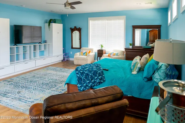 a living room with furniture rug and wooden floor