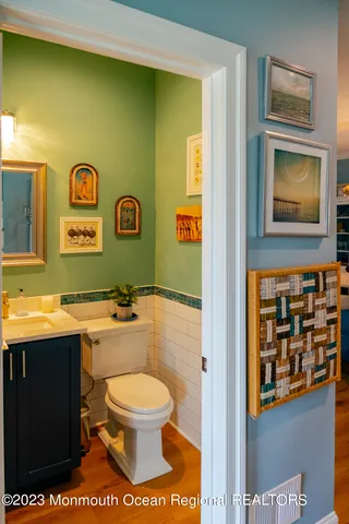 a bathroom with a toilet sink and mirror