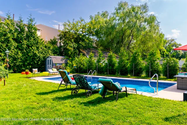 a view of swimming pool with lawn chairs
