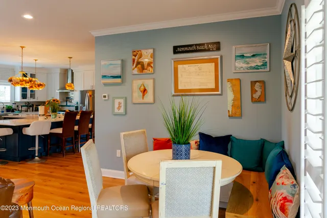 a dining room with furniture potted plants and wooden floor