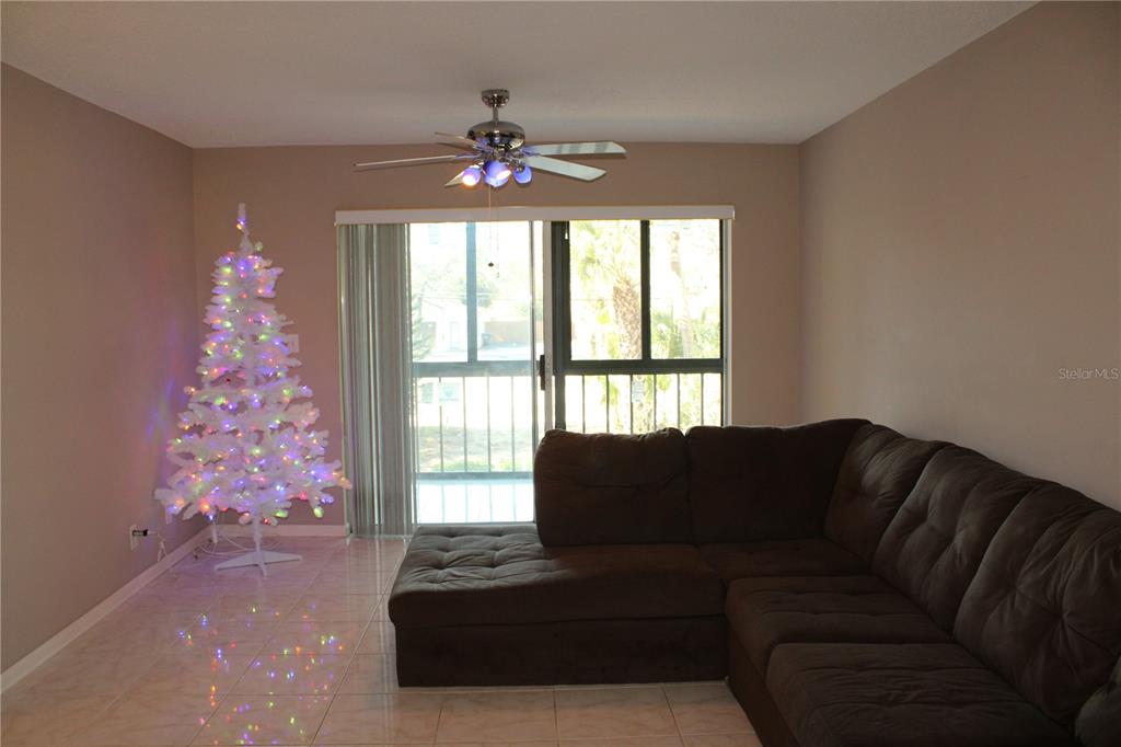 11485 Oakhurst Road, Unit 1200215 Largo, FL 33774 - Photo 11 of 68 a living room with furniture and a large window
