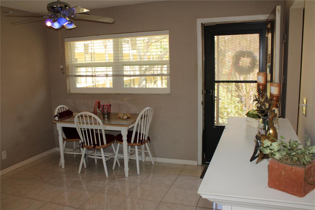 11485 Oakhurst Road, Unit 1200215 Largo, FL 33774 - Photo 12 of 68 a view of a dining room with furniture window and outside view