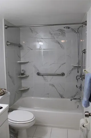 a living room with furniture a rug and a table