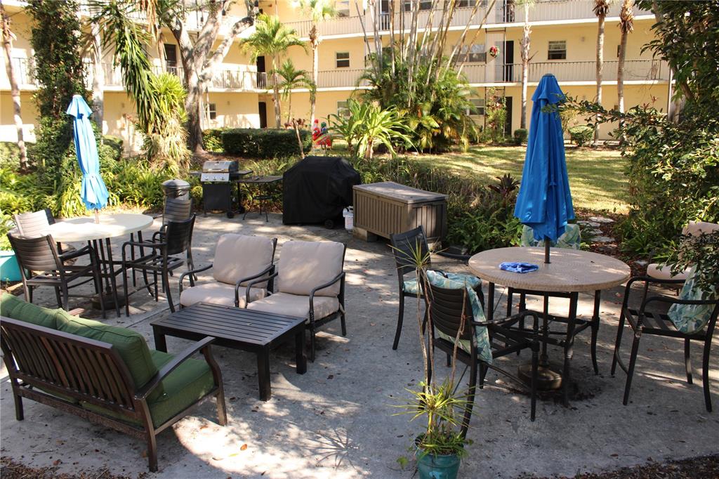 11485 Oakhurst Road, Unit 1200215 Largo, FL 33774 - Photo 37 of 68 a view of a patio with a table and chairs