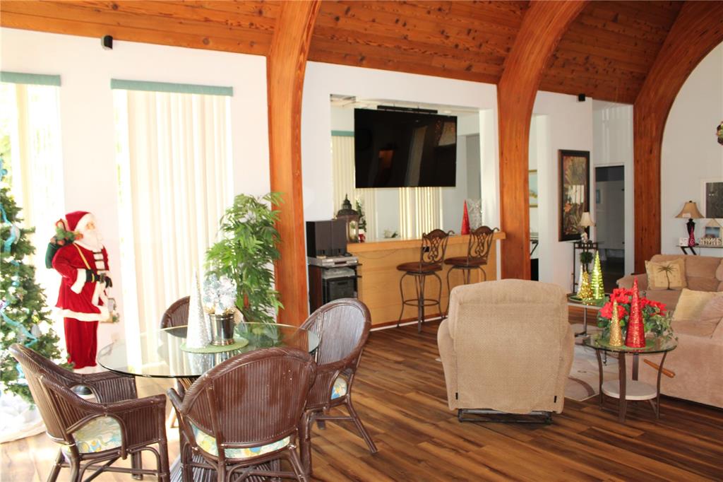 11485 Oakhurst Road, Unit 1200215 Largo, FL 33774 - Photo 40 of 68 a living room with furniture and a flat screen tv